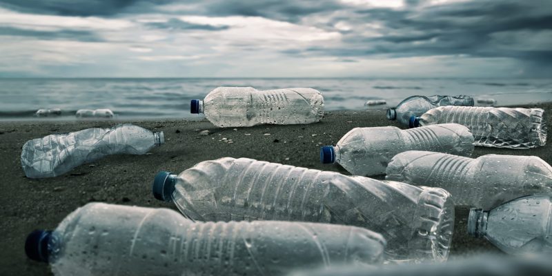 Plastic water bottles pollution in ocean (Environment concept)